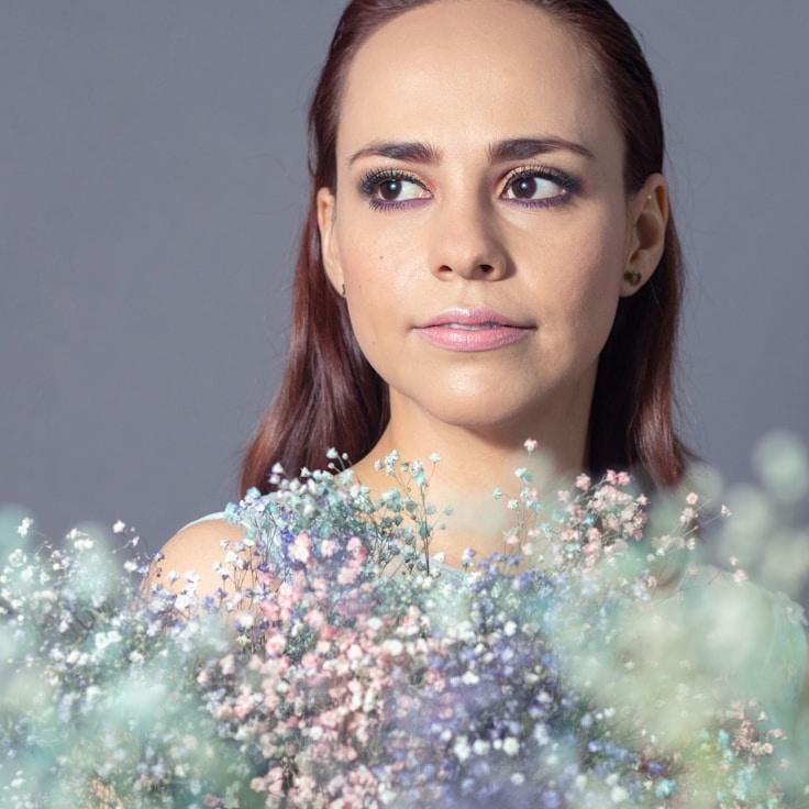 Nova Chen, Senior Design Curator at HavenCrestWorks, reviewing corporate flower arrangements